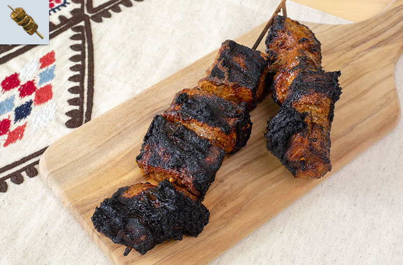 Two cooked meat skewers